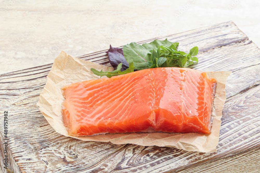 Raw salmon fillet over board Raw salmon fillet over board