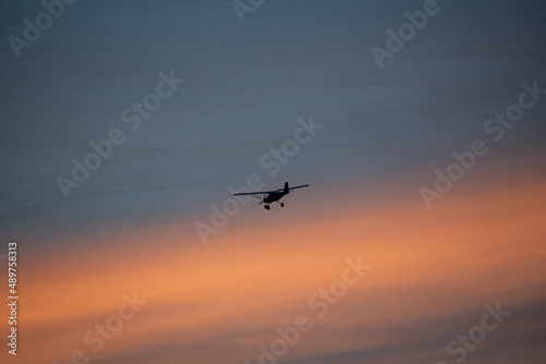 airplane flying in the sky, sunset © Michal