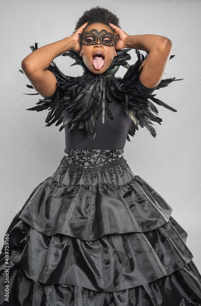 Black Woman in Feathered Black Dress with Fashionable Neckline Black Woman in Feathered Black Dress with Fashionable Neckline