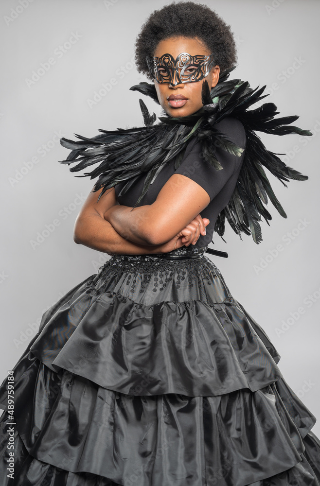 Black Woman in Feathered Black Dress with Fashionable Neckline