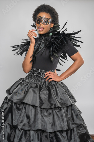 Black Woman in Feathered Black Dress with Fashionable Neckline