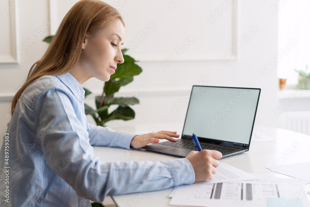 Beautiful woman with laptop and documents at home Beautiful woman with laptop and documents at home