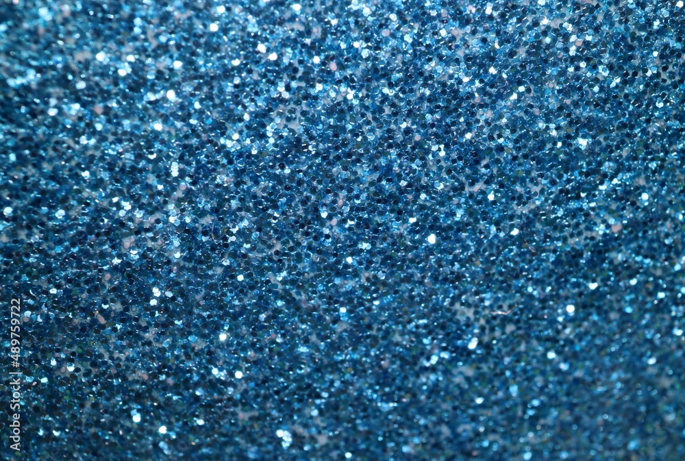 Sparkling vivid turquoise blue glitter macro close up for background texture