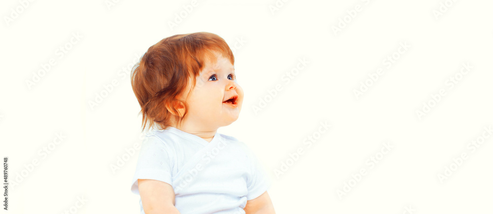 Portrait of happy cute little baby looking up on white background, banner blank copy space for advertising text Portrait of happy cute little baby looking up on white background, banner blank copy space for advertising text