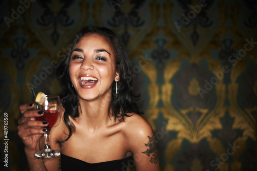 Shes got charisma and a cocktail - Night life. Portrait of a pretty girl having an awesome time while out partying - Copyspace.
