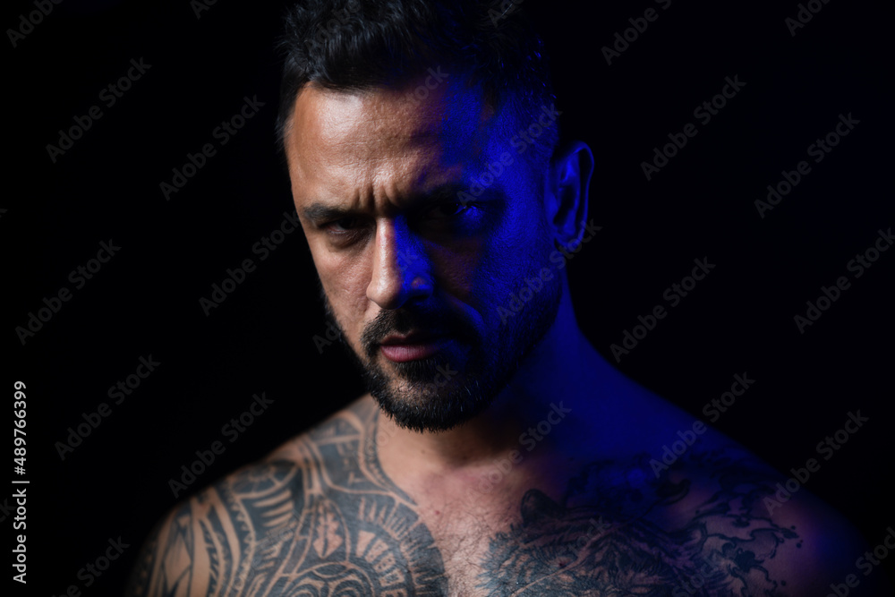 Obraz premium Seductive face of a sexy man. Macho looking confident. Close up portrait of guy with serious face.