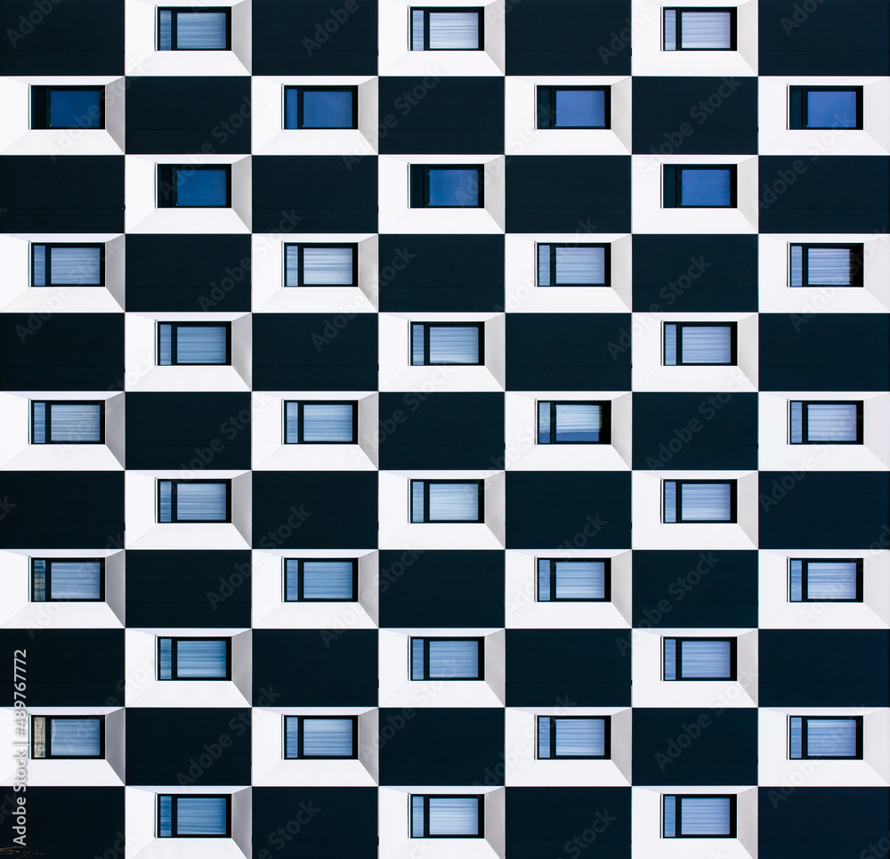 windows on a black and white facade windows on a black and white facade