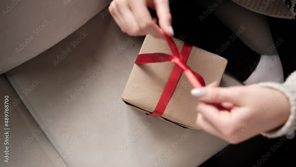 video of woman opening gift wrapped in sustainable paper
