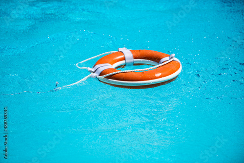 Drowning in water catch lifebuoy. Safety and urgent help. Resque needed. Life buoy floating in pool.