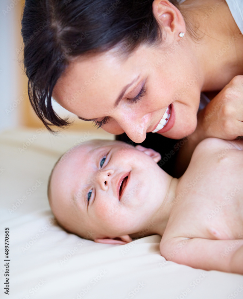 My moms the best. Happy baby boy smiling as his mother leans down to close to him. My moms the best. Happy baby boy smiling as his mother leans down to close to him.