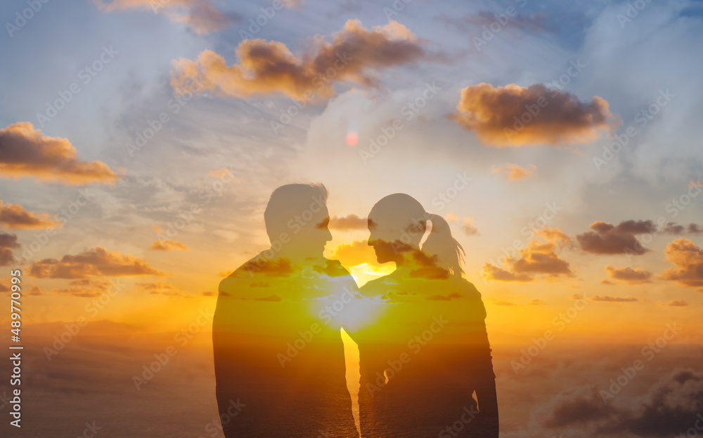 man and woman couple together facing sunrise. Love and relationship concept
