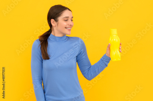 smiling woman hold mineral water. feel thirsty. young lady with sport plastic bottle.