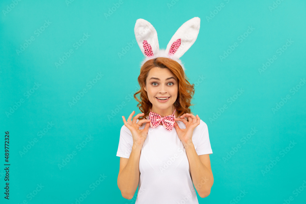 glad easter girl in bunny ears and bow tie on blue background