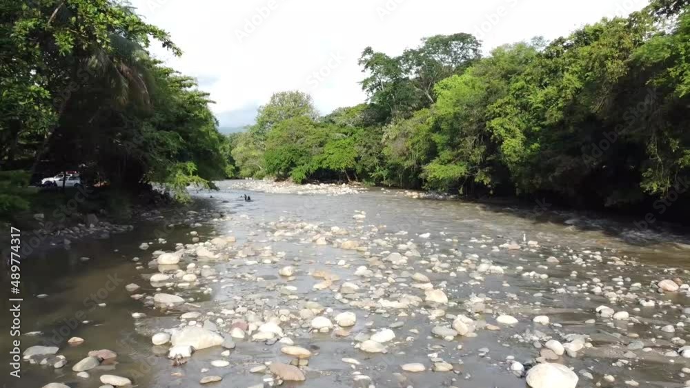 Hermoso río empedrado a lo largo del valle. Puente para cruzar