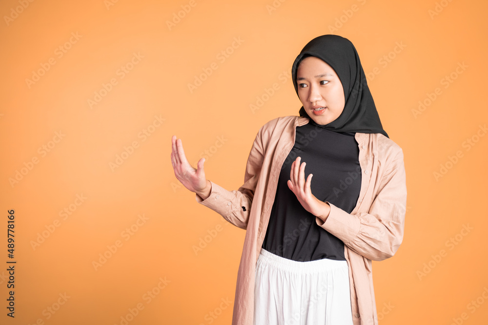Young asian muslim woman refusing with both palms gesture