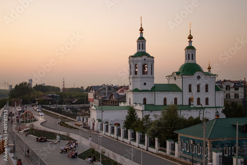 old church in cityscape on summer evening