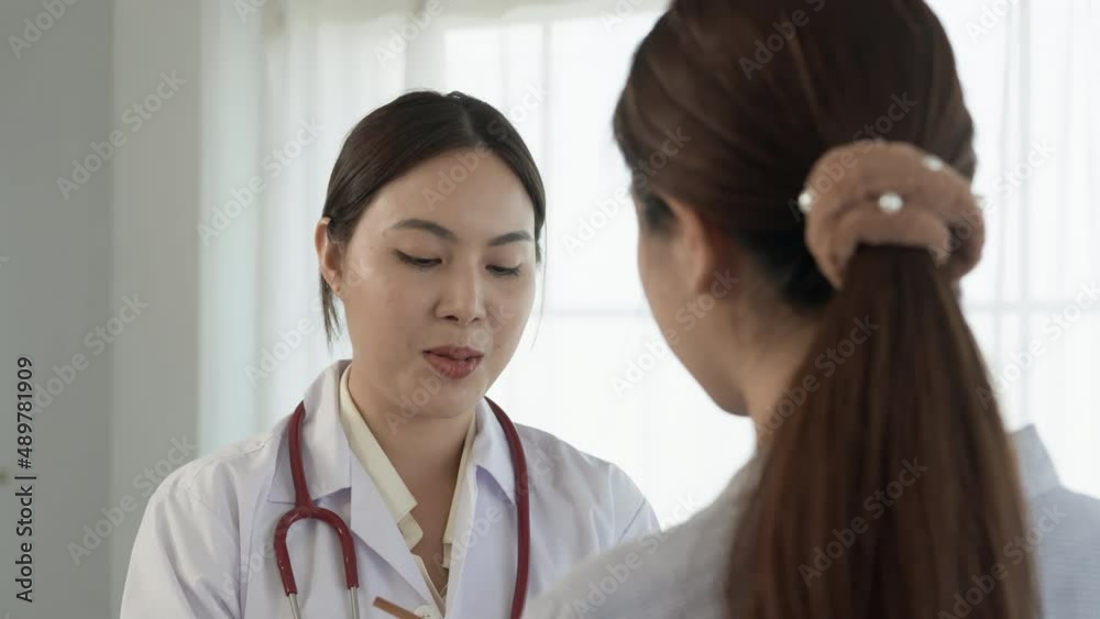 4K 50fps, long-haired Asian female doctor stands inquiring about the patient's condition and talking with a serious face. 4K 50fps, long-haired Asian female doctor stands inquiring about the patient's condition and talking with a serious face.