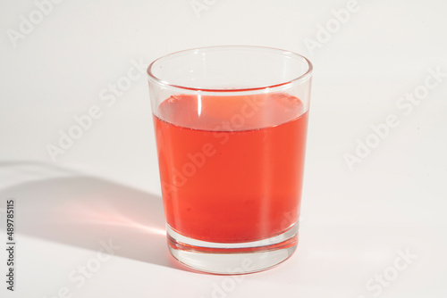 Glass of cranberry juice, vitamins.