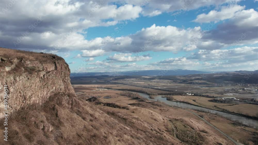 Aerial dolly shot, passing a cliff over the endless Romanian landscape at the end of winter. Aerial dolly shot, passing a cliff over the endless Romanian landscape at the end of winter.
