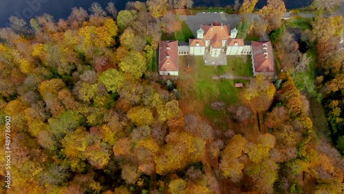 Scenic aerial flight over mist above forrest lake at sunrise, 4K footage. Colorful autumn trees at early morning light. Epic glory inspiration background. Palac Bielinskich w Otwocku Wielkim photo