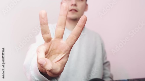 The young man's hands count to five. Counting with the fingers. . High quality 4k footage