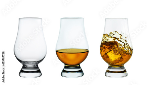set of whiskey glasses with ice isolated on white