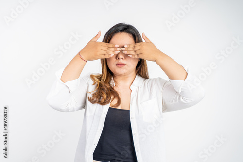 asian woman shut her eyes with hand