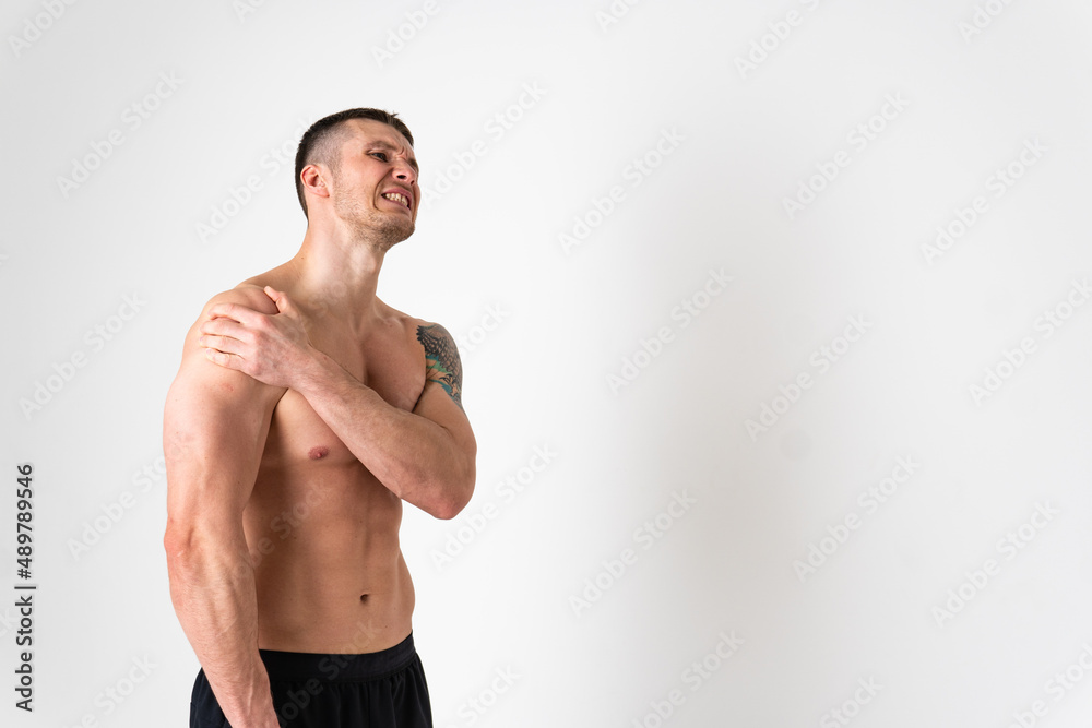 A sore shoulder joint muscle in a white man on a white background hurt injury, ill sick medical, muscular holding. Tension red care, disease suffer attractive A sore shoulder joint muscle in a white man on a white background hurt injury, ill sick medical, muscular holding. Tension red care, disease suffer attractive