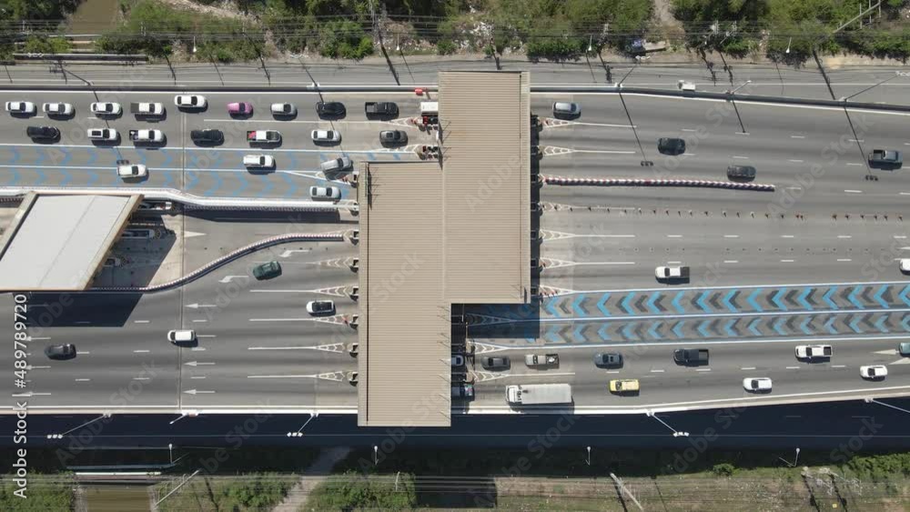 Aerial top down view Cars passing Toll gateway on Highway multi lane road. Aerial top down view Cars passing Toll gateway on Highway multi lane road.