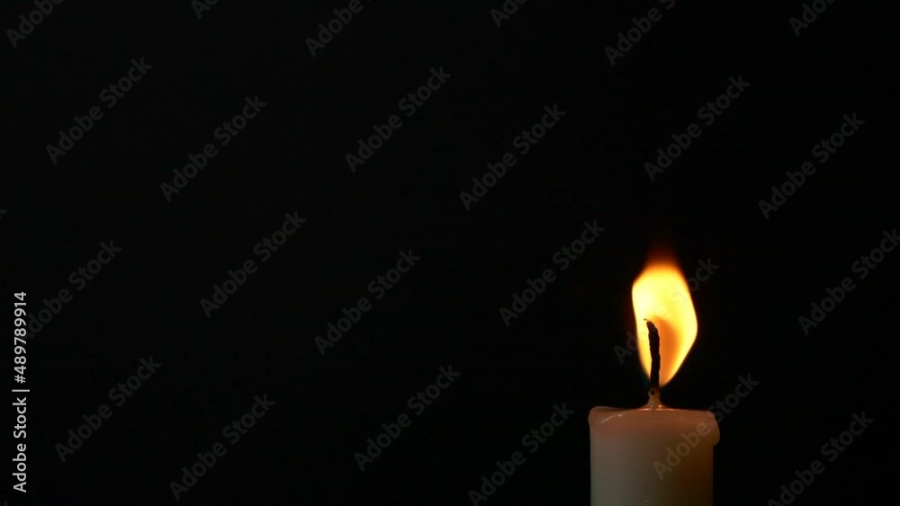 Slow motion closeup burning single candle flame isolated on black background, Slow motion closeup burning single candle flame isolated on black background,