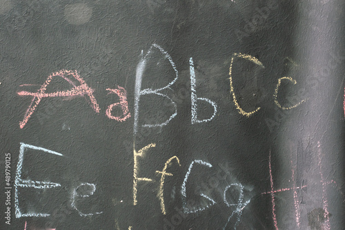 The coloured letters ABC are written by the child on the blackboard