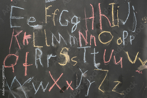 The coloured letters ABC are written by the child on the blackboard