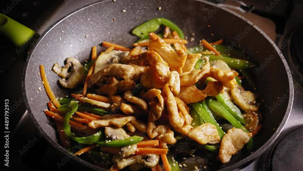 Adding Chicken Breast Pieces to Frying Pan, Stirring in Pan, Asian Food Adding Chicken Breast Pieces to Frying Pan, Stirring in Pan, Asian Food