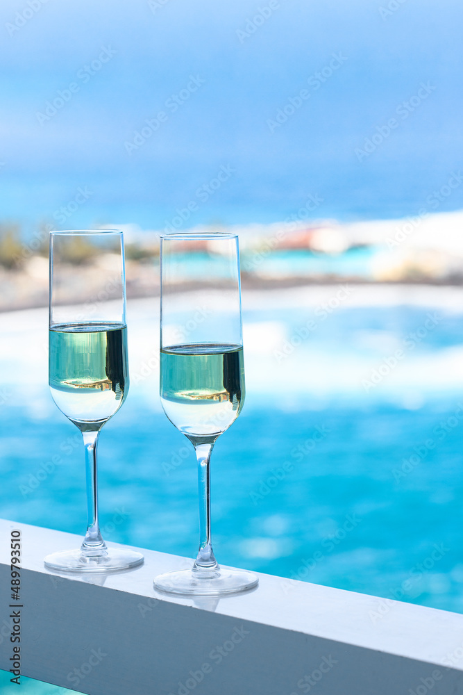 Two champagne glass on hotel room with beautiful azure ocean view in tropical country. Two champagne glass on hotel room with beautiful azure ocean view in tropical country.