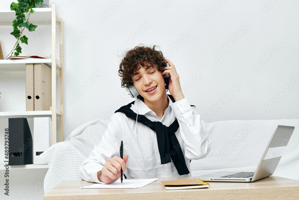Fototapeta premium guy in headphones with a book at home Lifestyle technology