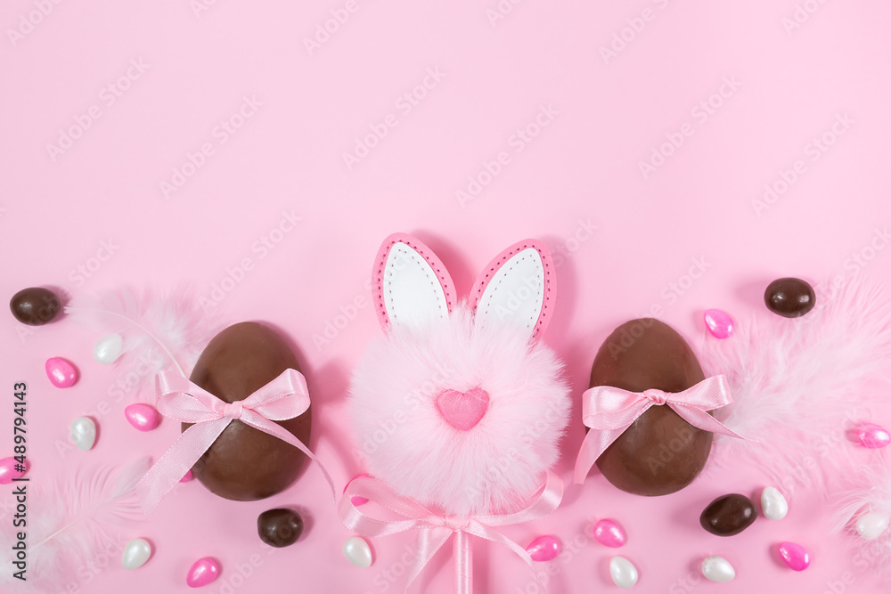 Colorful Easter chocolate eggs, flat lay on pink background. Happy Easter. Stylish Easter layout. Greeting card or banner template Colorful Easter chocolate eggs, flat lay on pink background. Happy Easter. Stylish Easter layout. Greeting card or banner template