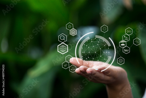 Technology, hand holding with environment Icons over the Network connection on green background