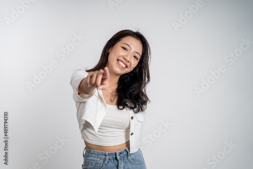 woman smiling while pointing her finger toward camera