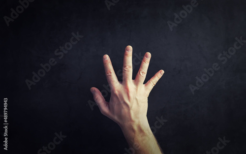 Finger gestures. Male hands on a gray background. Gesticulation with hands. © alexkich
