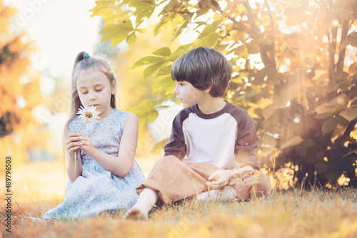 Children walk in the park in autumn. Child outdoors on a sunny summer morning in the park.