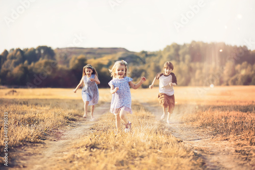 Children walk in the park in autumn. Child outdoors on a sunny summer morning in the park.