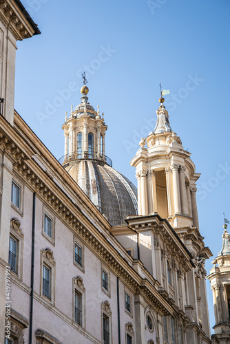 Marble pillars  spires  and statues that are typical of churches in Rome  Italy 