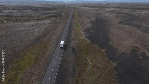 Truck driving endless road in flat volcanic Iceland landscape, Hringvegur ring road, aerial photo