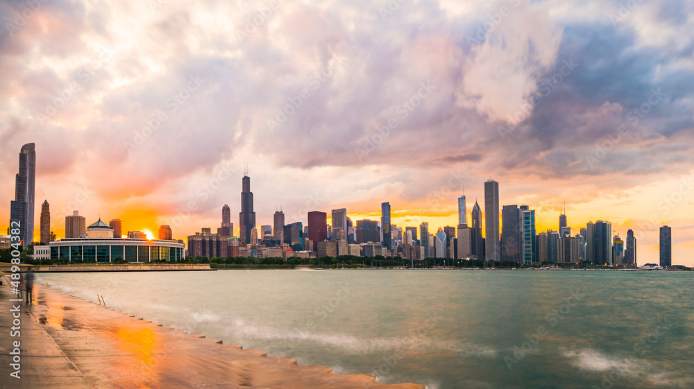 Chicago skyline at sunset with cloudy sky and reflection in water,chicago,illinois,usa.