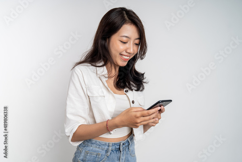 beautiful asian woman using mobile cell phone typing text