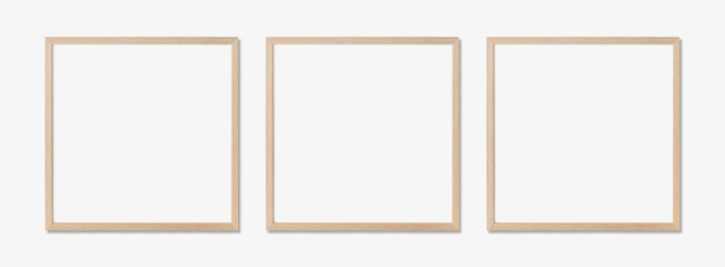 Picture frame mockup. Set of three square oak wooden frames on white wall. Template for artwork, painting or poster.