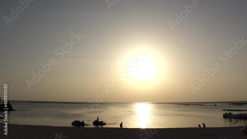 CHTAN-CHO, OKINAWA, JAPAN - AUG 2021 : View of Araha beach (Ocean or sea) in sunset time. Wide view, long time lapse shot, dusk to night. Summer holiday, vacation and resort concept shot. photo