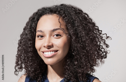 Beautiful smiling young woman closeup portrait, Joyful cheerful african american girl studio shot.