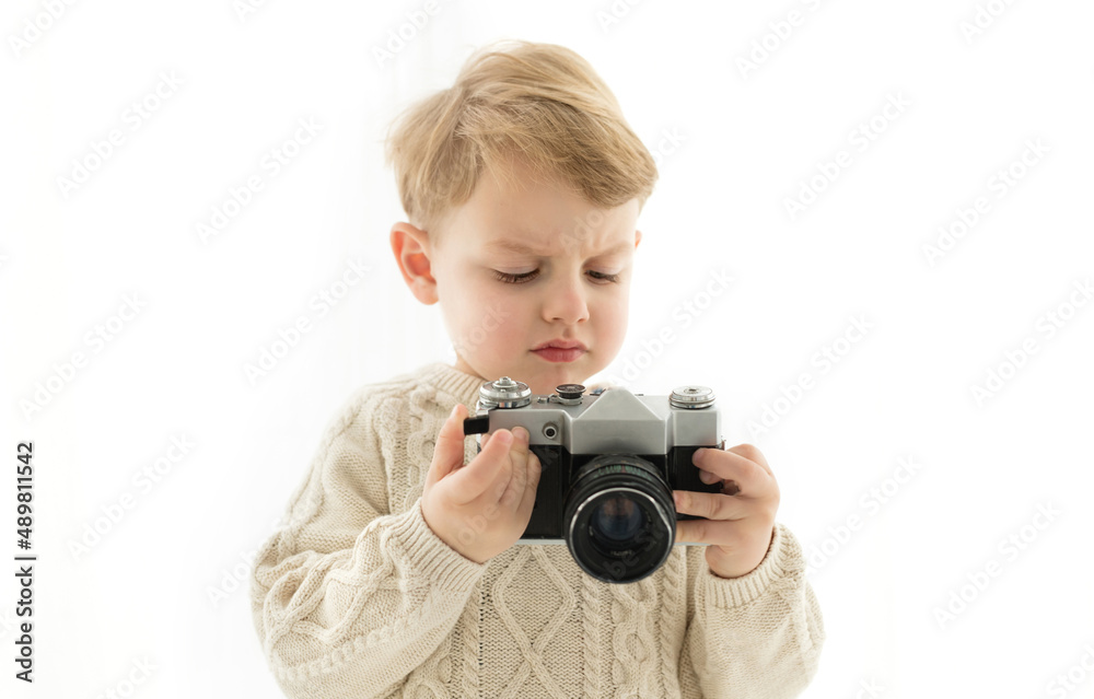 A little boy with a camera in his hands
