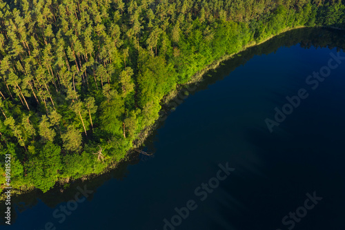 Aerial view of forested shore of Giesenschlagsee lake in summer photo